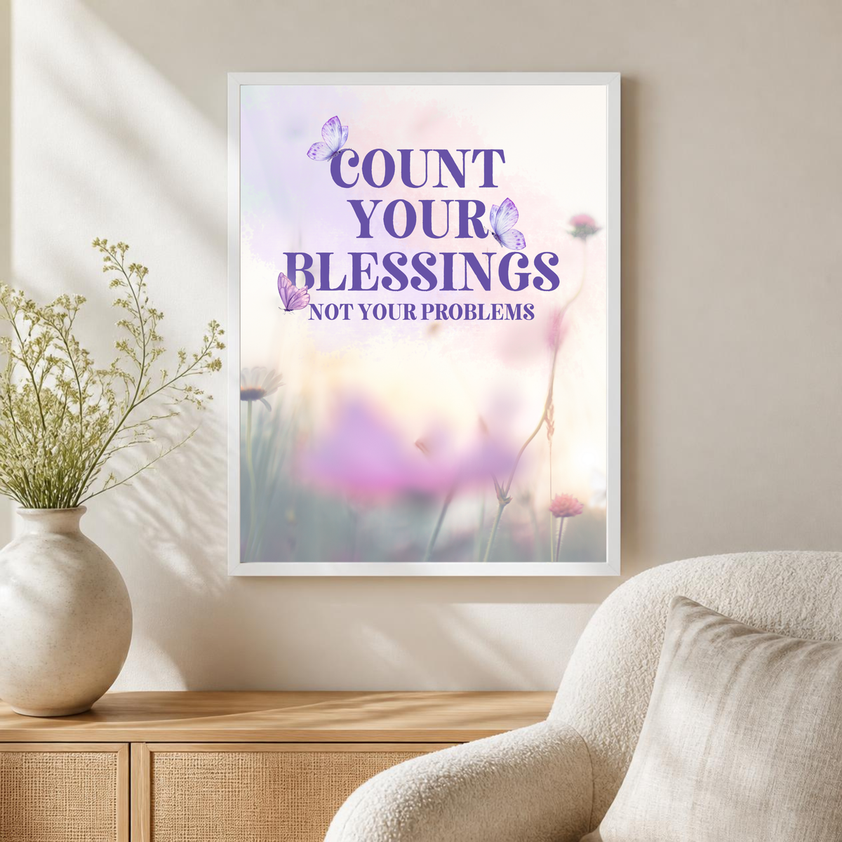 White-framed Count Your Blessings, Not Your Problems butterfly poster displayed in a warm neutral room