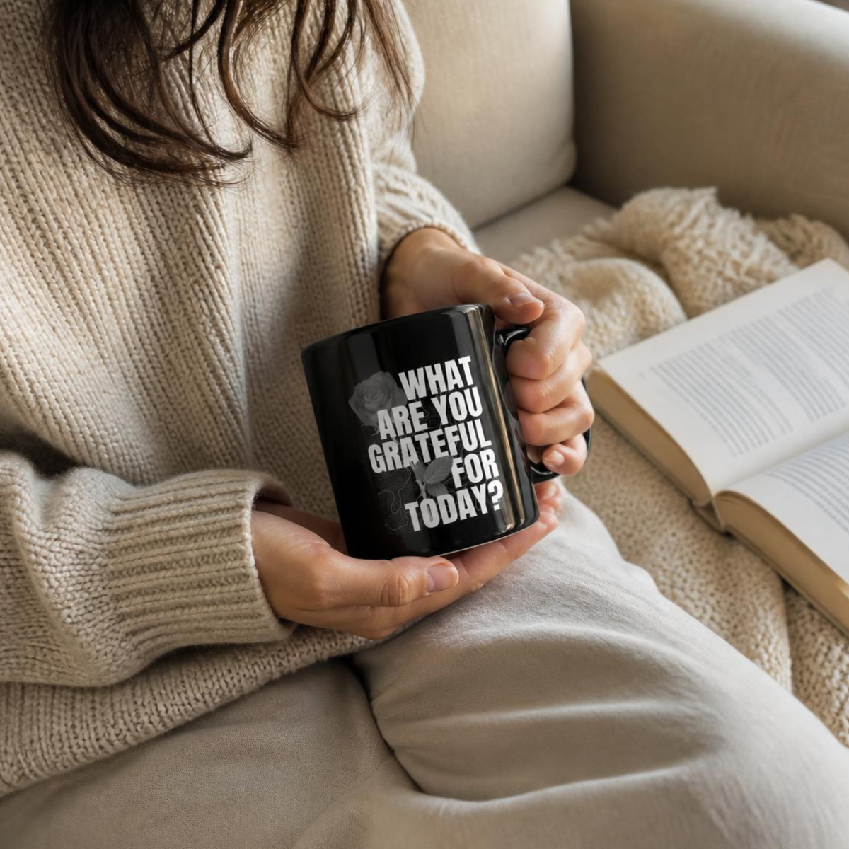 Black gratitude mug with coffee beside a notebook in a warm natural-light lifestyle setting